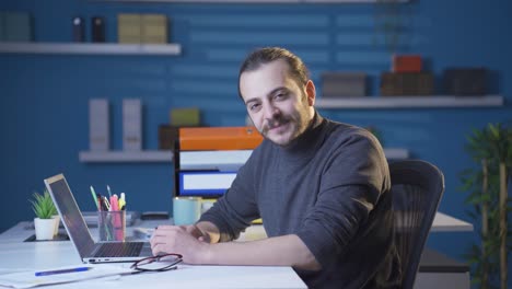 Happy-and-friendly-home-office-worker-smiling-at-camera.