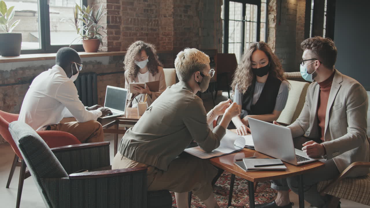 Group of Multi-Ethnic Colleagues Working Together in Coworking Office
