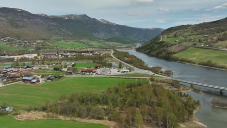 otta norway - otta river and road e6 from dombaas and trondheim passing through countryside residential area