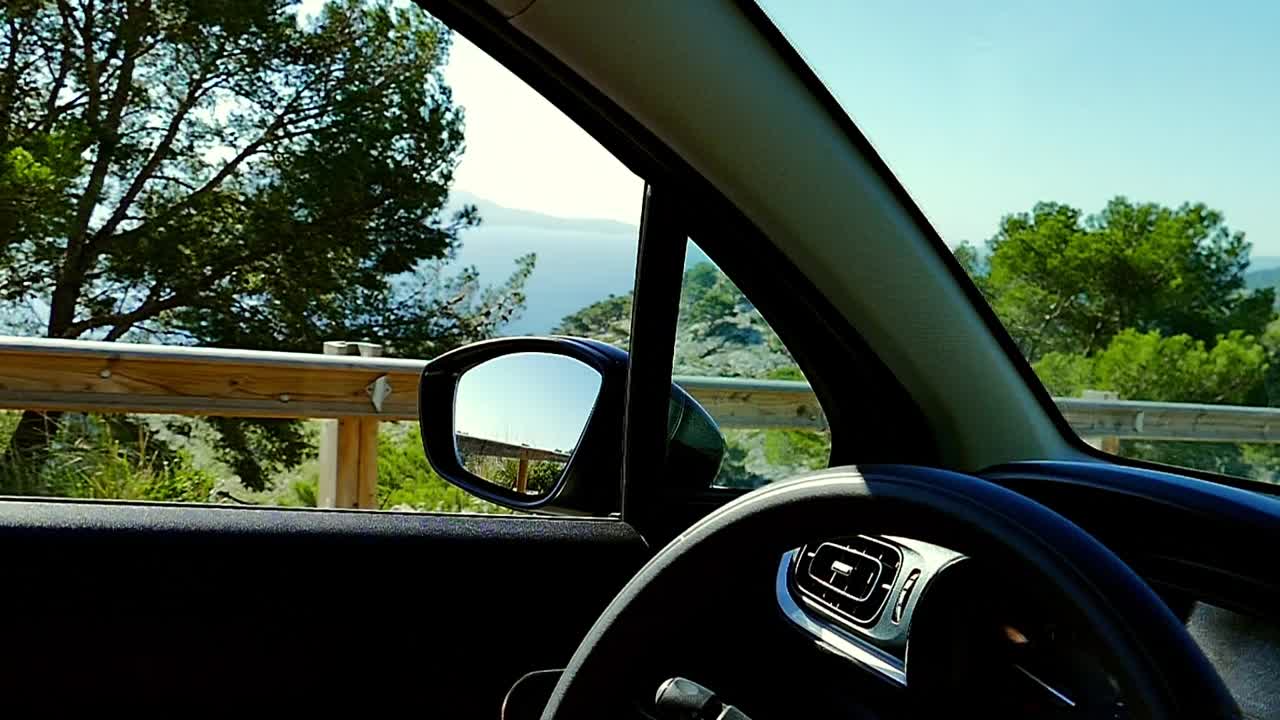 Driving car in the mountainous location near the seaside in the slow motion (120fps) in Mallorca, Spain