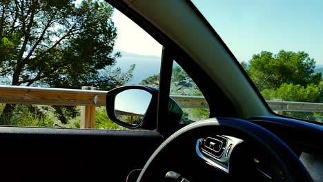 driving car in the mountainous location near the seaside in the slow motion (120fps) in mallorca, spain