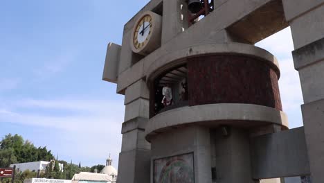 Bell-tower-with-saint-inside-moving-hands-at-Mexico