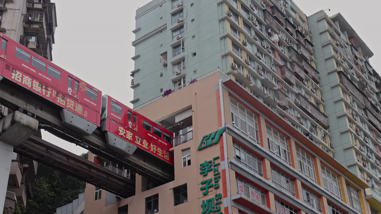 CHONGQING, CHINA - 28 MAY 2025 : train enters liziba station inside a building on bridge in Chongqing china