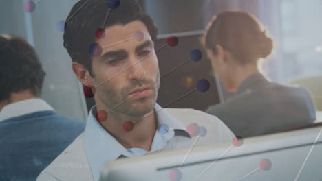 Dna-structure-and-changing-numbers-over-caucasian-man-using-computer-at-office