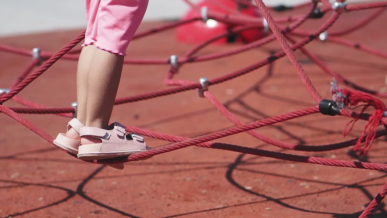 Child on a rope climbing frame