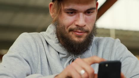 bmx rider using smartphone in an empty warehouse