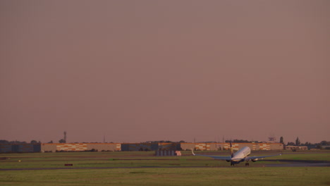 airplane taking off at sunset