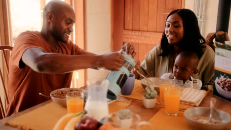 happy family having breakfast at home in the morning