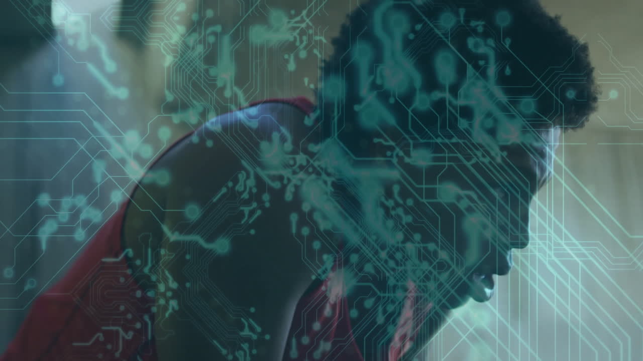 Overlaying animation of digital circuit, athlete wearing red jersey in action