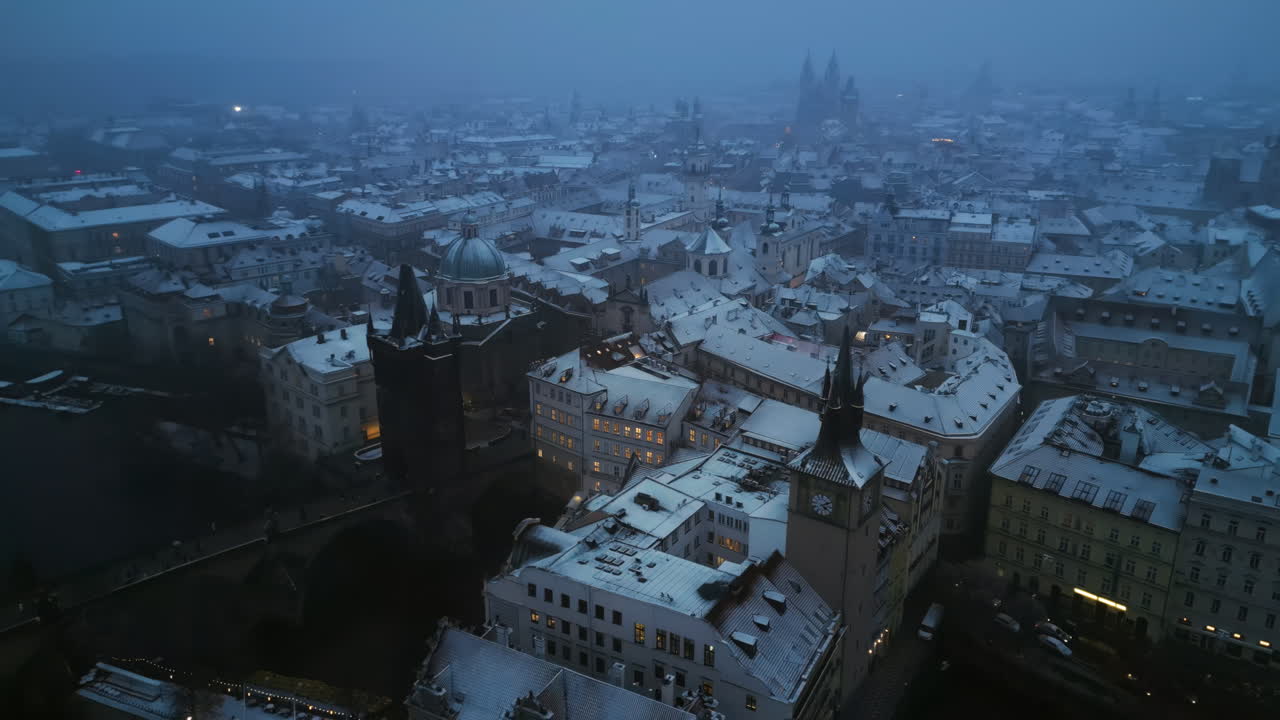 Aerial drone view of the Old Town square covered in snow in the evening. Winter in Prague, Czech Republic
