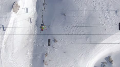 skiers on chairlift from above