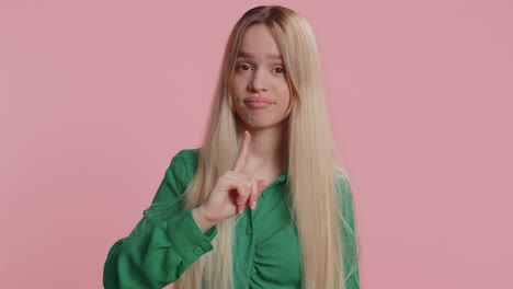 caucasian young woman shakes finger and saying no be careful avoid danger mistake disapproval sign