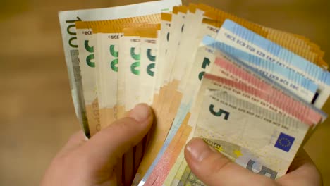 Manos-De-Mujer-Contando-Una-Pila-De-Dinero-En-Efectivo-En-Euros