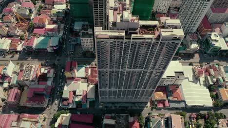 aerial view looking down onto city buildings and apartment blocks in phnom penh, cambodia