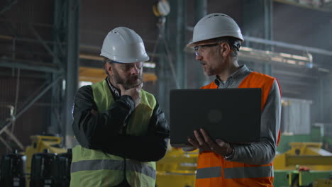 Factory Engineers Discussing a Problem