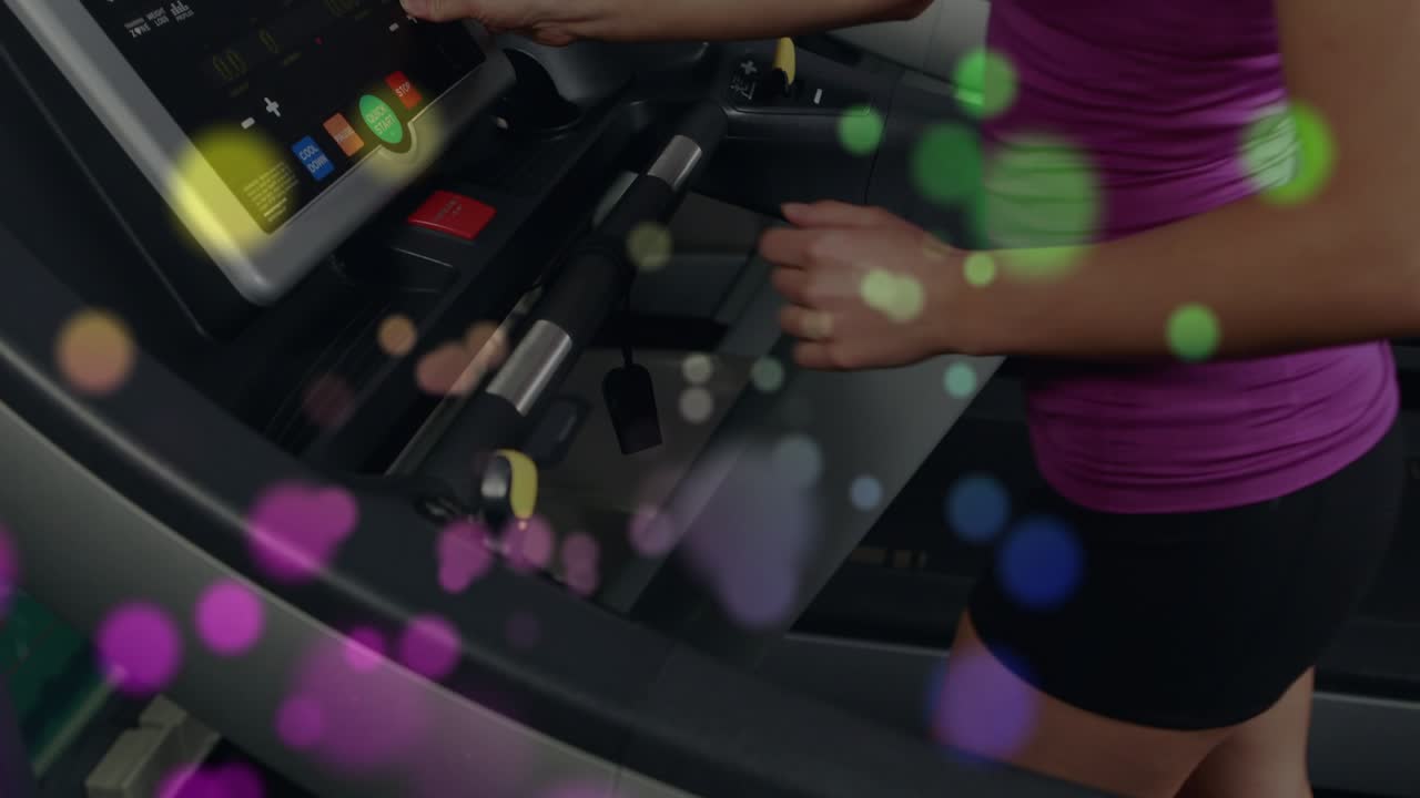 Woman tapping console touchscreen, starting workout, stepping onto belt and running as bokeh drifts