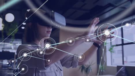 Animation of network of connections over asian businesswoman using vr headset
