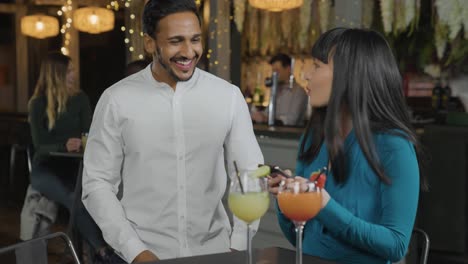 tracking shot of a man approaching woman in a bar