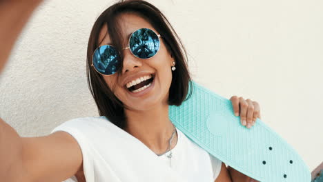 happy woman taking a selfie with a pop-it skateboard