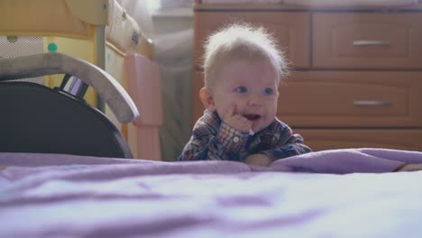 funny-boy-in-warm-shirt-plays-with-plastic-tube-at-bed