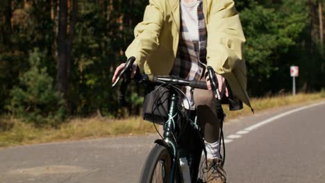 people cycling on a forest road