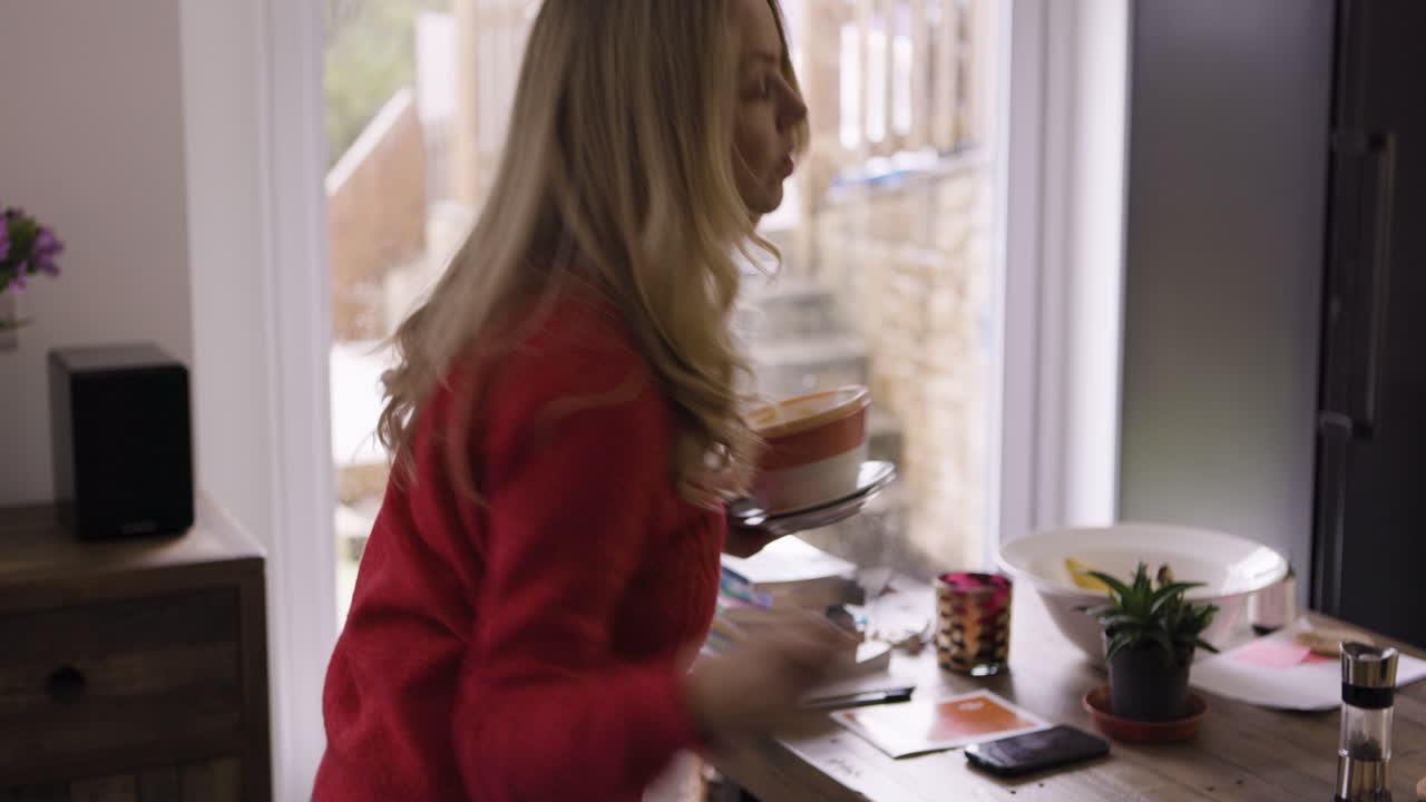 Woman in kitchen holding bowl