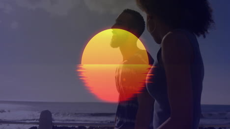 silhouetted couple walking on beach with vibrant sunset animation overlay