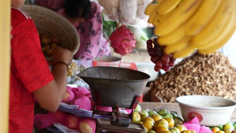 an indonesian man is serving buyers in a traditional wet market.