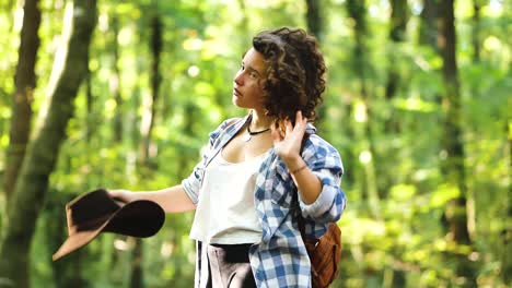 traveling woman with hat in forest