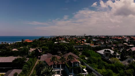 Drone-rising-above-the-villas-in-Canggu-at-the-beach,-Canggu-Bali-Indonesia
