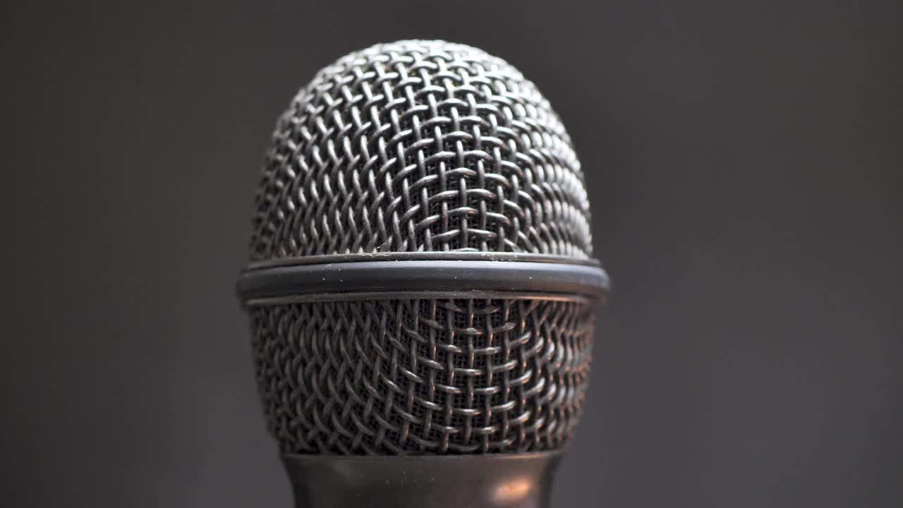 Extreme closeup of old dirty stereo microphone head, spinning. Macro shot.  Scene F.