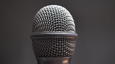 extreme closeup of old dirty stereo microphone head, spinning. macro shot.  scene f.