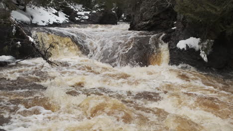 Spring-snowmelt-surges-over-a-small-waterfall