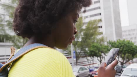 African-american-using-her-smartphone-in-street