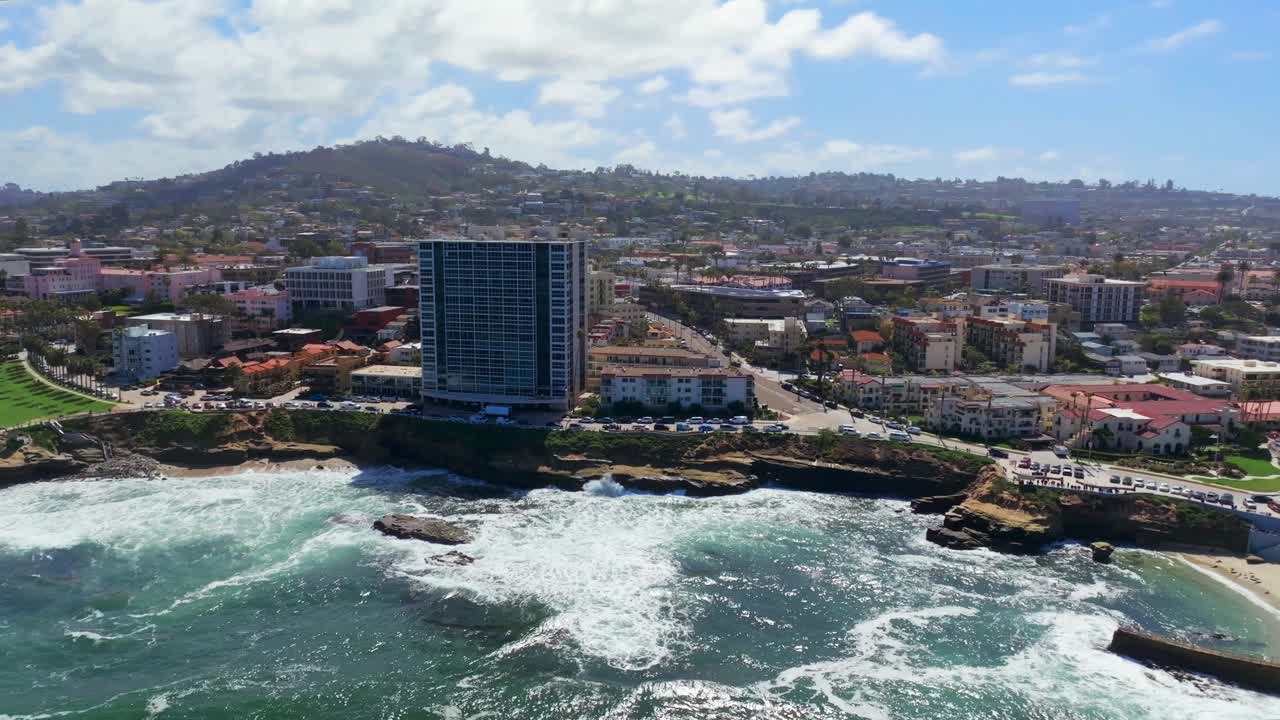 Aerial View Of High-rise Office Building With Waves Crashing On Shell Beach And Children's Pool La Jolla In California, United States