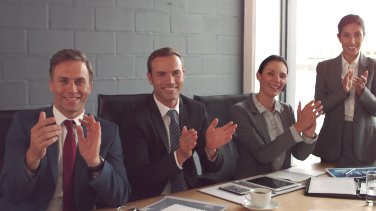 Business people applauding a colleague 