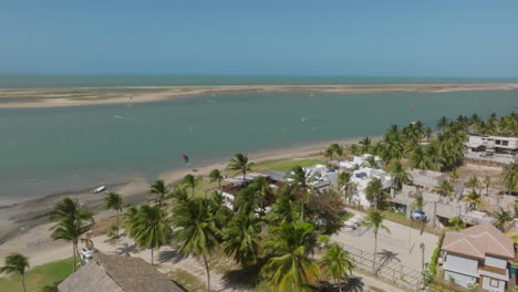kitesurfers ride across lagoon in ilha do guajiru, brazil, tropical and sunny vibes