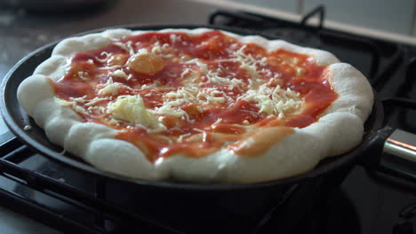 hands putting mozzarella on top of the most authentic italian pizza