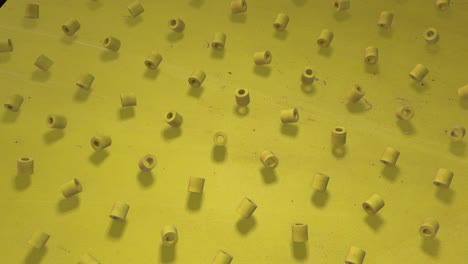 Cheerful Yellow. 3D animation of a seamless contour background of sunny bright yellow cubes, bagels, cylinders, rotating. Great for presentations. Put your own text in it