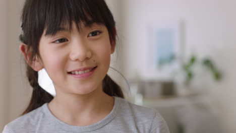 portrait of happy little asian girl smiling playfully making faces enjoying fun positive childhood 4k footage