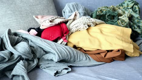 pile of clothes on a couch