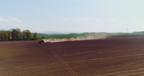 tractor working in beautiful spacious agricultural field 6