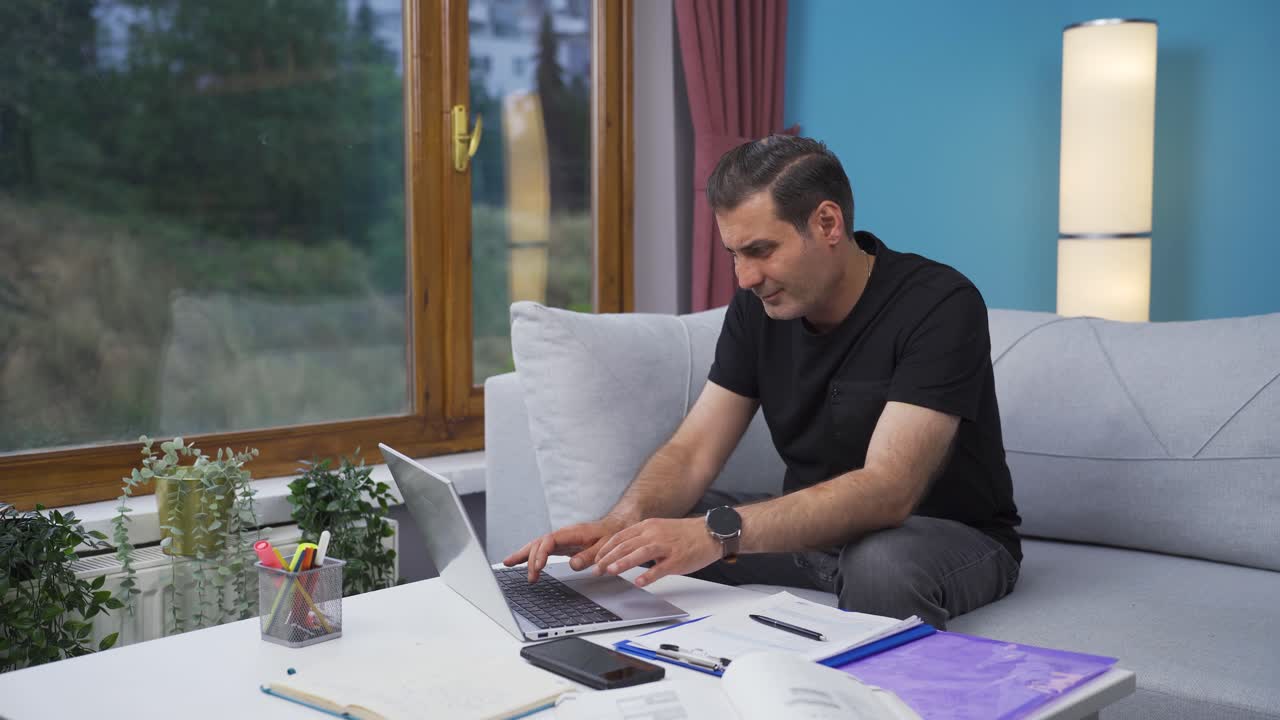 Home office worker man working on laptop.