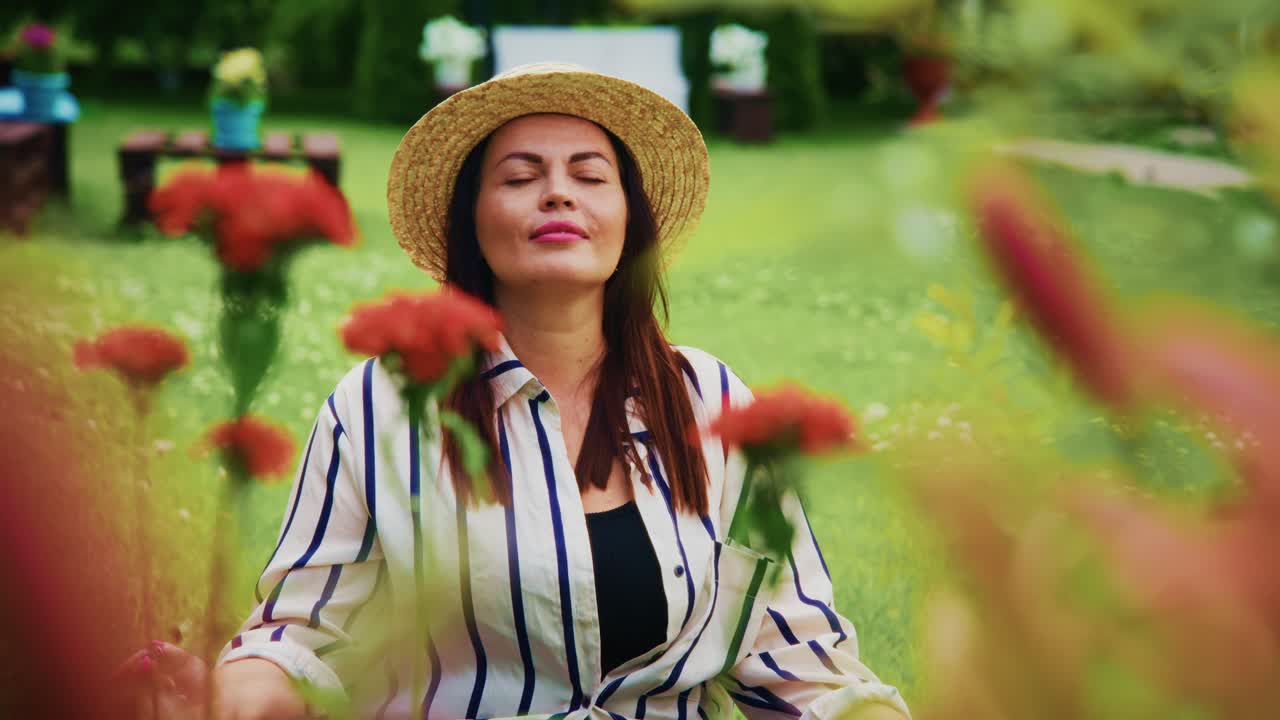 Woman enjoying nature in a vibrant garden surrounded by colorful flowers and greenery