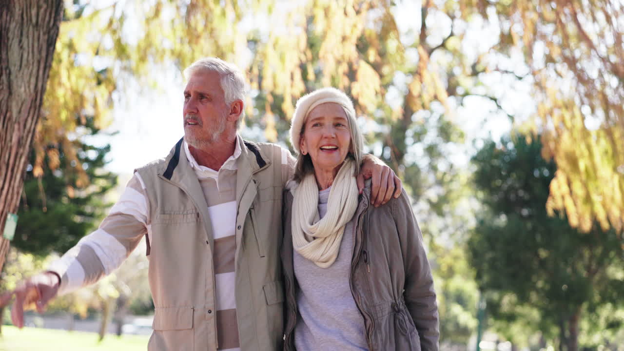An elderly couple enjoying a walk in the park