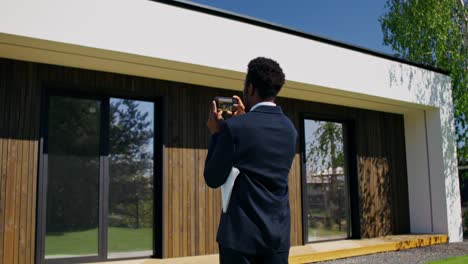 real estate agent taking pictures of modern house