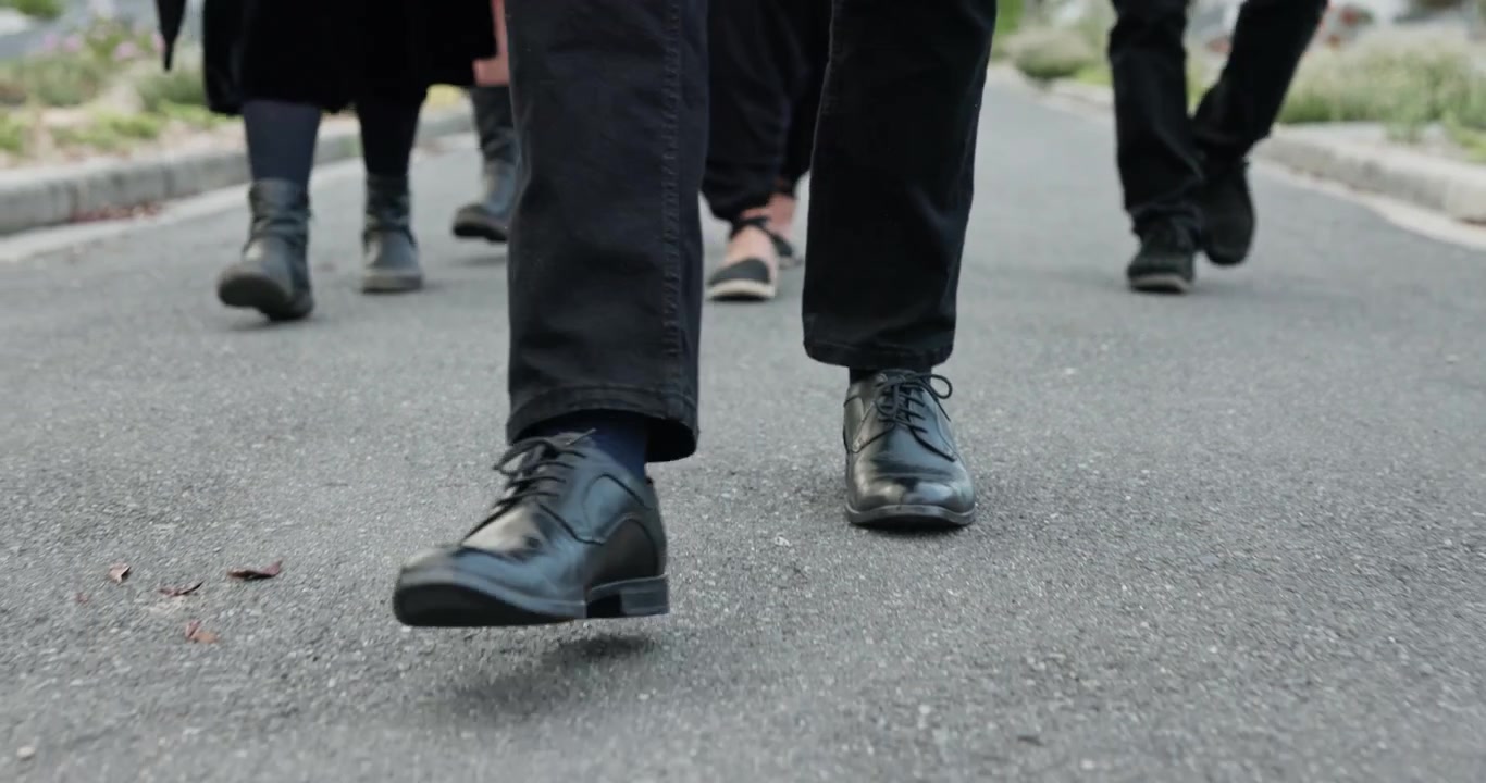 Group of People Walking Together on Asphalt Road