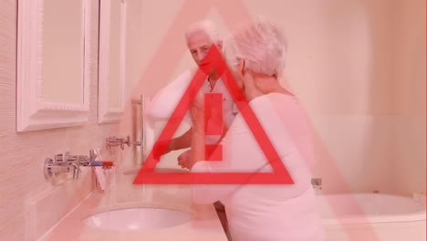 triangle warning sign over seniors washing hands in the background. covid-19 spreading