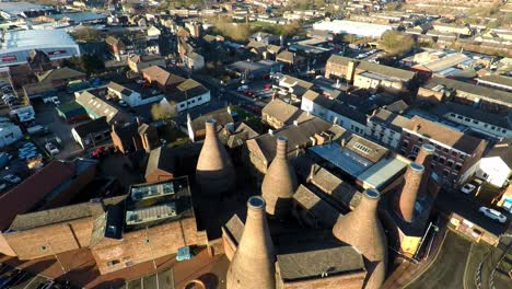 Aerial-view-of-the-famous-bottle-kilns-of-Gladstone-Pottery-Museum,-formerly-used-in-manufacturing-in-the-city-Stoke-on-Trent,-Staffordshire,-industrial-decline,-poverty-and-cultural-demise