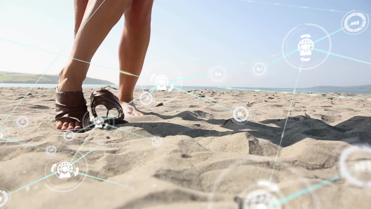 Persona che cammina su una spiaggia sabbiosa, con animazione di connessioni di rete digitali.